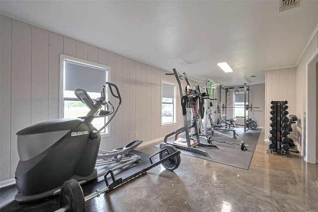 exercise room with visible vents and a decorative wall