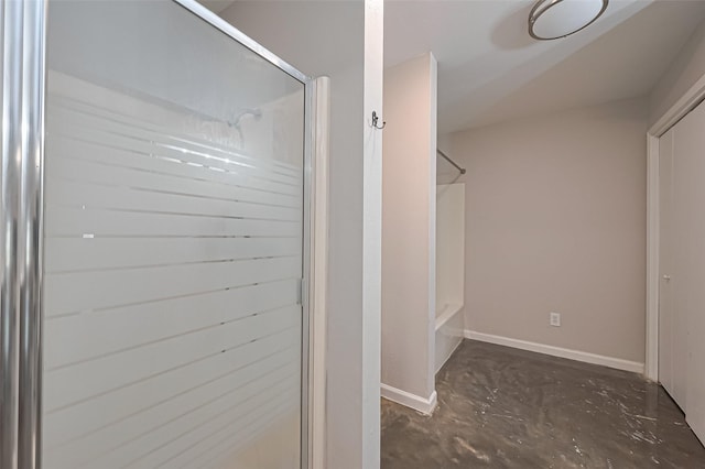 interior space featuring unfinished concrete floors and baseboards