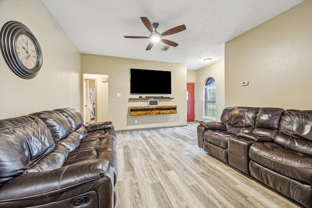living area featuring ceiling fan, visible vents, and light wood-style floors