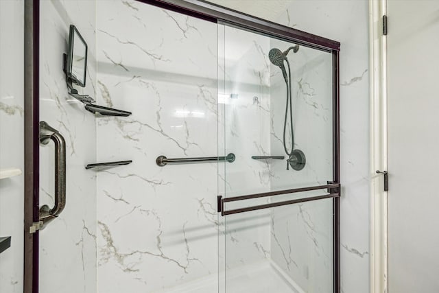 full bath with a marble finish shower