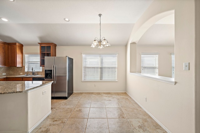 7234 Rambling Tree Ln, Richmond, TX 77407 - kitchen with plenty of natural light, glass insert cabinets, a sink, and stainless steel fridge