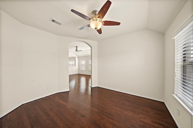 7234 Rambling Tree Ln, Richmond, TX 77407 - unfurnished room with vaulted ceiling, wood finished floors, visible vents, a ceiling fan, and arched walkways