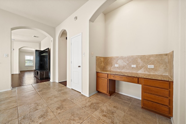 7234 Rambling Tree Ln, Richmond, TX 77407 - hallway featuring arched walkways, visible vents, and baseboards