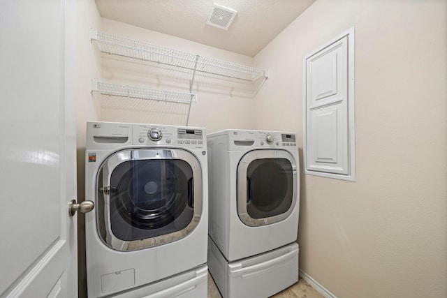 7234 Rambling Tree Ln, Richmond, TX 77407 - washroom with separate washer and dryer, baseboards, visible vents, and laundry area