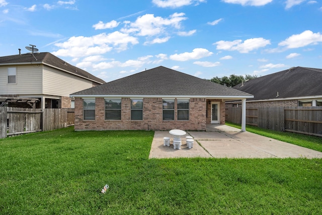 7234 Rambling Tree Ln, Richmond, TX 77407 - rear view of property featuring a lawn, a fenced backyard, brick siding, and a patio area