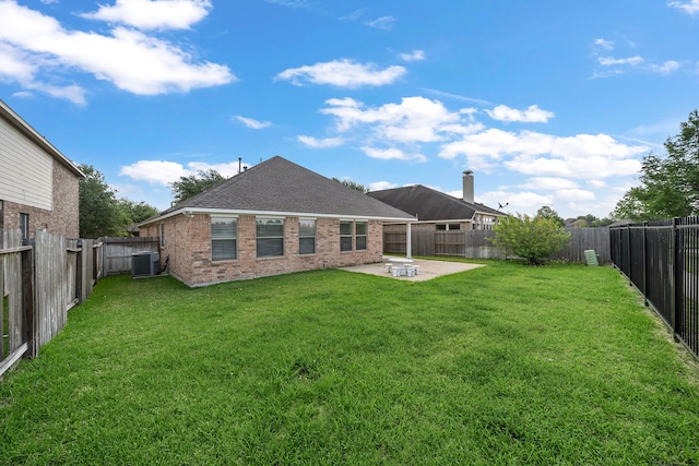 7234 Rambling Tree Ln, Richmond, TX 77407 - back of property with a fenced backyard, central AC unit, a patio, and a lawn