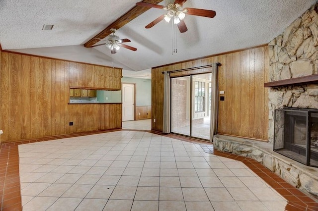 4249 County Road 571, West Columbia, TX 77486 - unfurnished living room with a textured ceiling, wooden walls, ceiling fan, and vaulted ceiling with beams