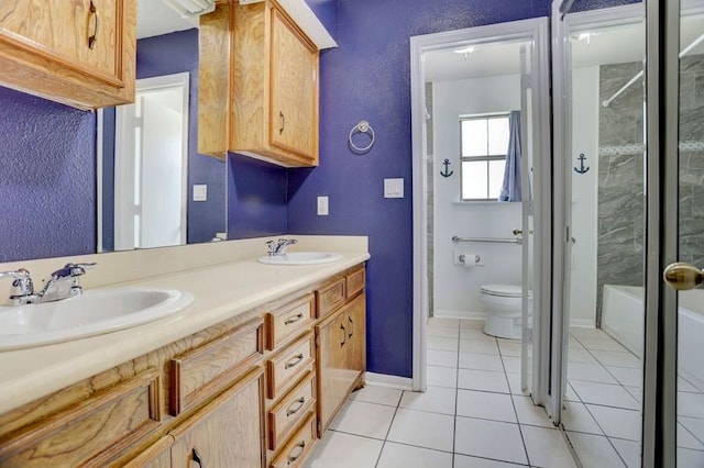 4249 County Road 571, West Columbia, TX 77486 - bathroom featuring tile patterned floors, toilet, double vanity, and a sink