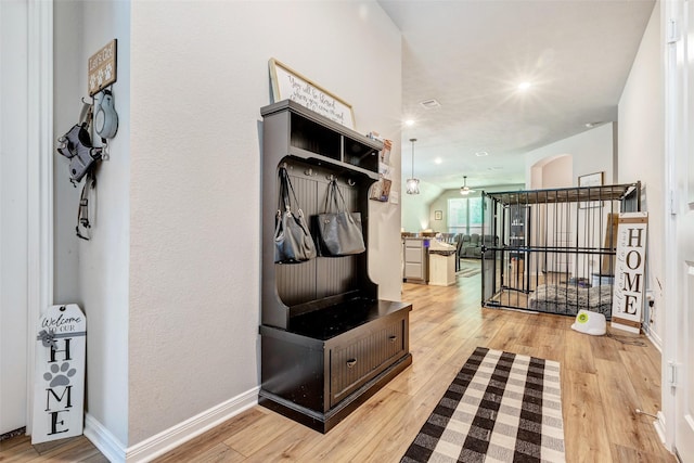 108 Alessandra Way, Huntsville, TX 77320 - mudroom with arched walkways, light wood finished floors, and baseboards