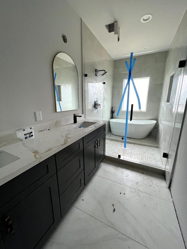6405 Sidney St, Houston, TX 77021 - full bathroom featuring vaulted ceiling, double vanity, a walk in shower, a sink, and a freestanding tub