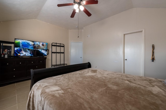 bedroom with lofted ceiling, a ceiling fan, and tile patterned flooring