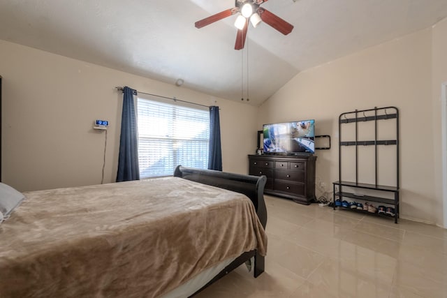 bedroom with ceiling fan, lofted ceiling, and light tile patterned floors
