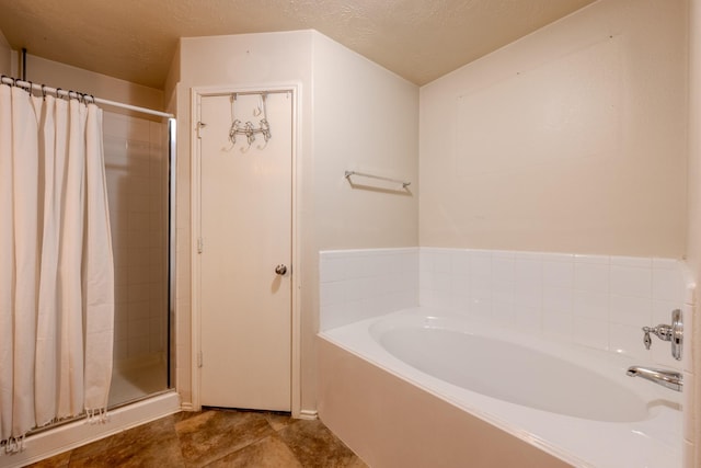 bathroom with a shower stall and a garden tub