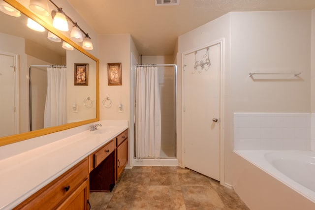 bathroom with visible vents, a garden tub, vanity, and curtained shower