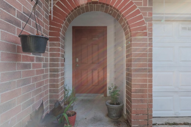 entrance to property with brick siding