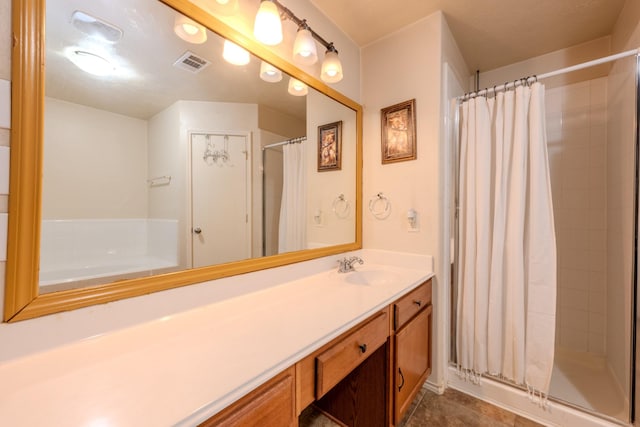full bathroom with tile patterned floors, visible vents, vanity, and a stall shower
