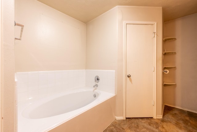 full bath with a bath and baseboards