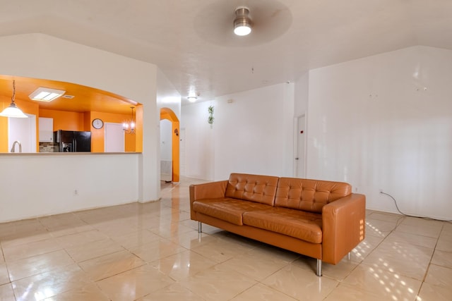 interior space with arched walkways and ceiling fan