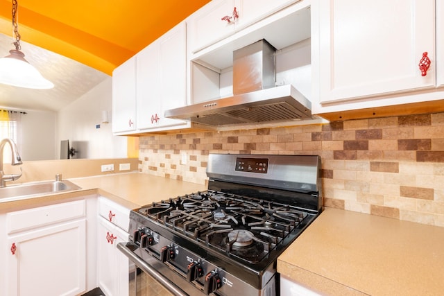 kitchen with a sink, tasteful backsplash, stainless steel gas range, wall chimney range hood, and light countertops