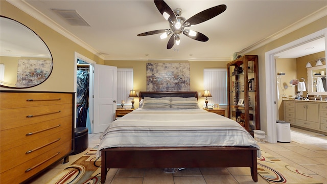 bedroom with a spacious closet, ensuite bath, ornamental molding, and visible vents