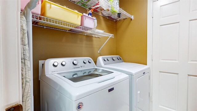 washroom with washer and clothes dryer and laundry area