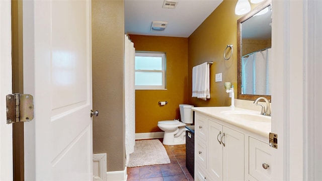 bathroom with baseboards, visible vents, vanity, and toilet
