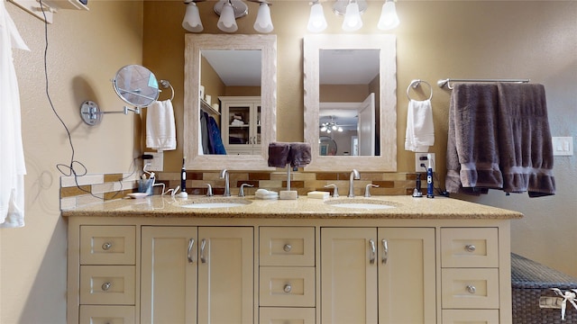 full bath with a sink and double vanity