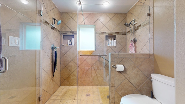 bathroom featuring a shower stall and toilet