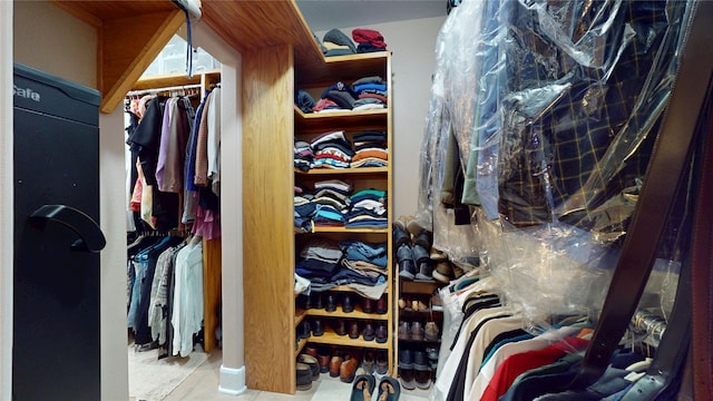 walk in closet with tile patterned flooring