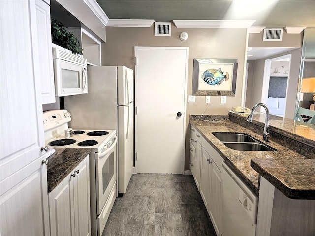 kitchen with visible vents, white appliances, a sink, and crown molding