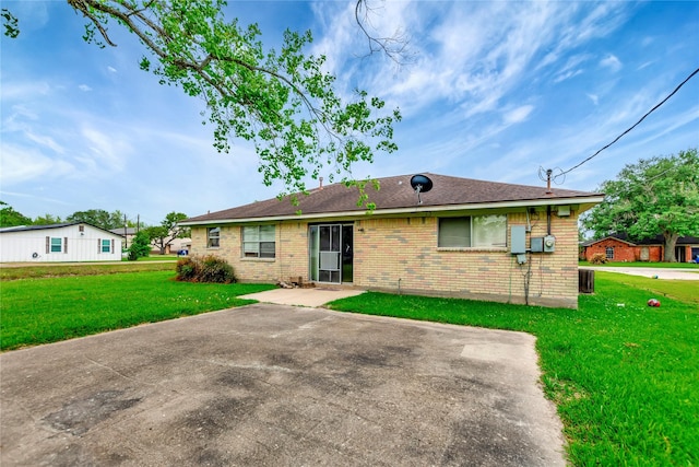 1419 Avenue Ave E, Danbury, TX 77534 - back of property featuring a patio, a yard, and brick siding