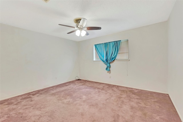 1419 Avenue Ave E, Danbury, TX 77534 - spare room featuring baseboards, carpet flooring, and a ceiling fan