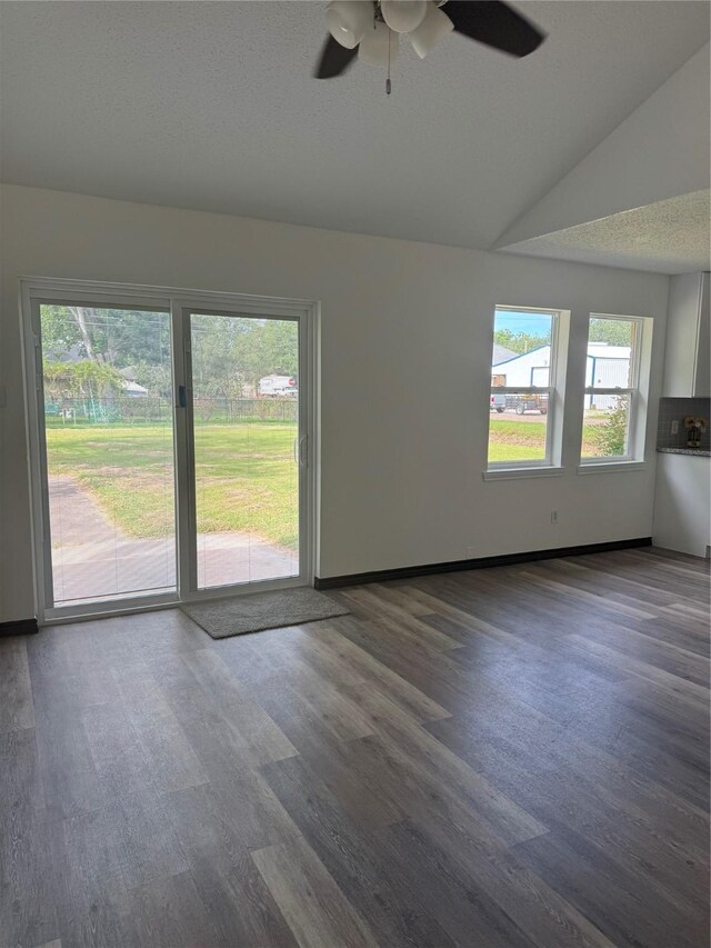 1419 Avenue Ave E, Danbury, TX 77534 - empty room featuring ceiling fan, lofted ceiling, and dark wood-type flooring
