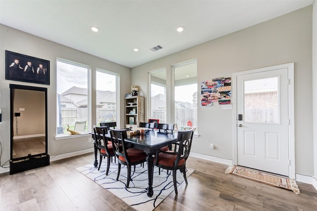 dining area with light wood finished floors, baseboards, visible vents, and recessed lighting
