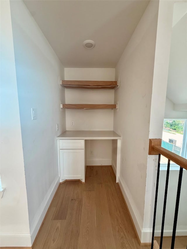 923 Fisher St Unit A, Houston, TX 77018 - unfurnished office featuring light wood finished floors, built in desk, and baseboards