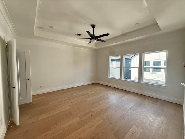 923 Fisher St Unit A, Houston, TX 77018 - spare room featuring a raised ceiling, light wood-type flooring, a ceiling fan, crown molding, and baseboards