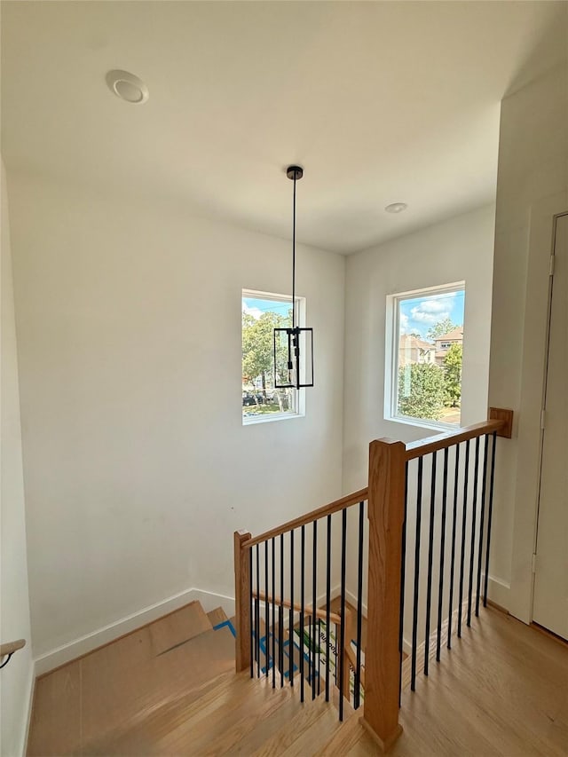 923 Fisher St Unit A, Houston, TX 77018 - stairway with plenty of natural light, wood finished floors, baseboards, and a chandelier