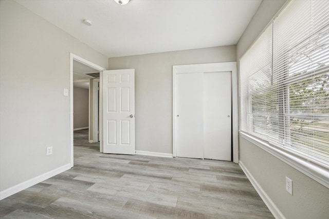 5835 Kenilwood Dr, Houston, TX 77033 - unfurnished bedroom with baseboards, wood finished floors, and a closet