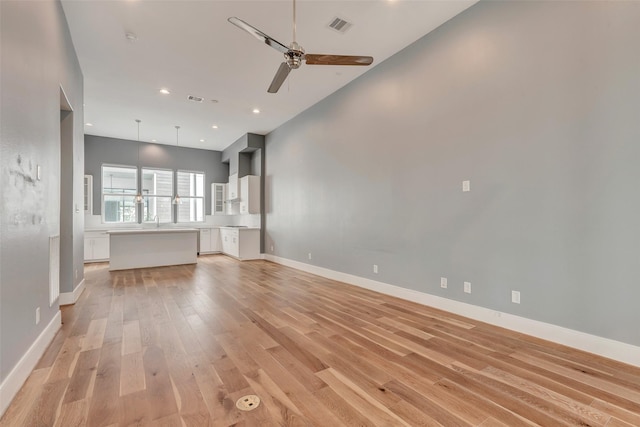 unfurnished living room featuring light wood finished floors, recessed lighting, ceiling fan, visible vents, and baseboards