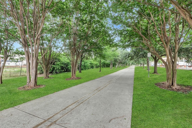 view of property's community with a lawn
