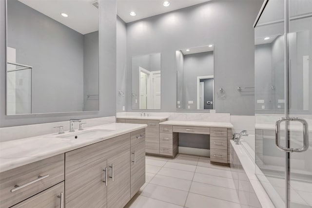 bathroom featuring tile patterned floors, two vanities, a shower stall, a sink, and a garden tub