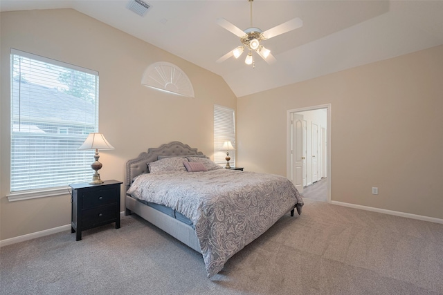 bedroom with light colored carpet, visible vents, multiple windows, and lofted ceiling