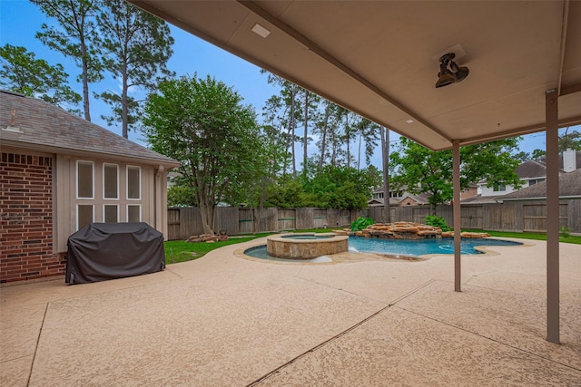 view of patio with an in ground hot tub, a fenced in pool, a fenced backyard, and a grill