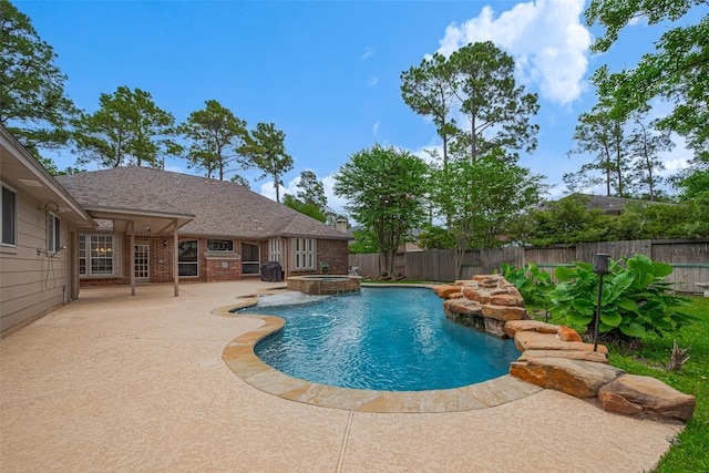 view of pool with a fenced in pool, a fenced backyard, a patio area, and an in ground hot tub