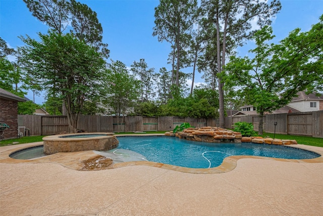 view of pool featuring a pool with connected hot tub, a fenced backyard, and a patio area