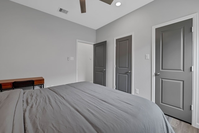bedroom featuring recessed lighting, ceiling fan, visible vents, and wood finished floors