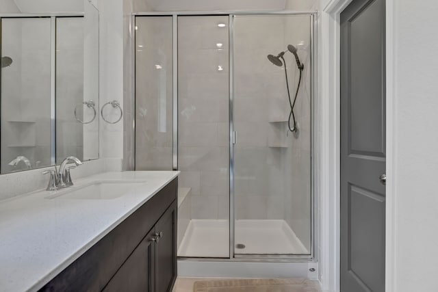 bathroom featuring vanity and a shower stall