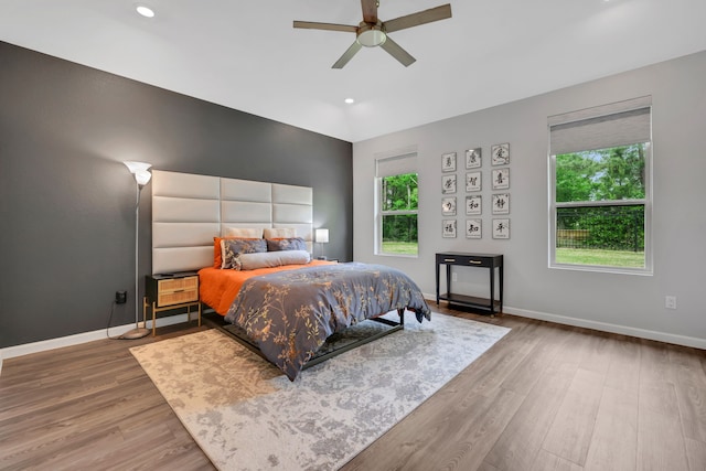 bedroom featuring baseboards, recessed lighting, and wood finished floors