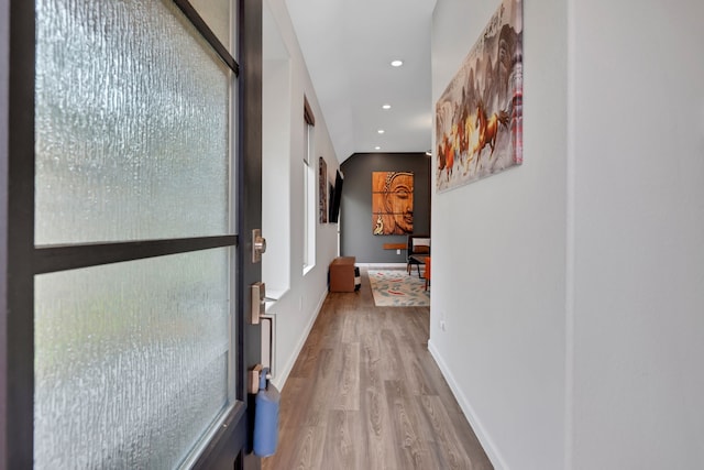 hallway with baseboards, recessed lighting, and wood finished floors