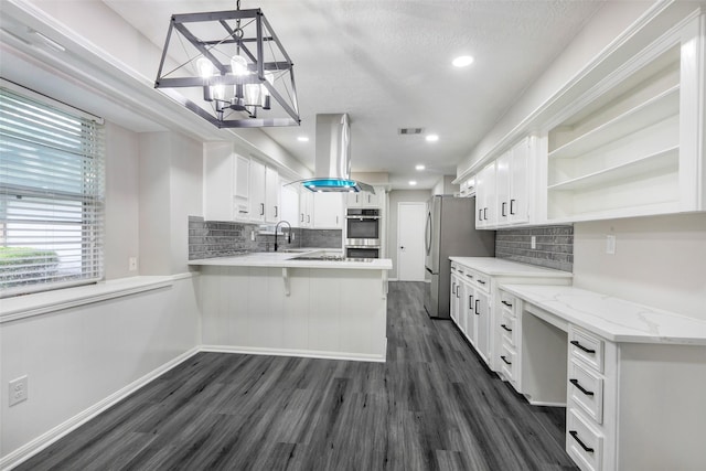 kitchen with island exhaust hood, a notable chandelier, open shelves, a peninsula, and dark wood-style flooring